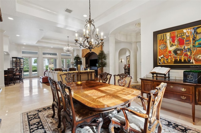 dining space with arched walkways, recessed lighting, visible vents, ornamental molding, and a raised ceiling