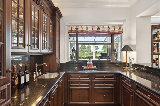 bar with crown molding, tasteful backsplash, and a sink