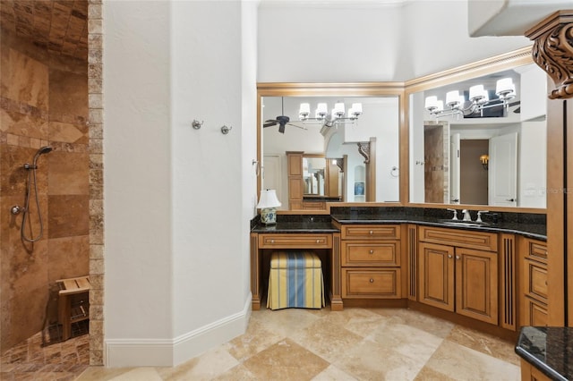 full bathroom featuring a walk in shower, vanity, and baseboards