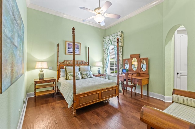 bedroom featuring baseboards, ornamental molding, dark wood finished floors, and arched walkways