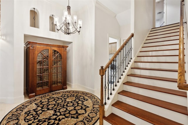 interior space with baseboards, french doors, stairway, and a notable chandelier