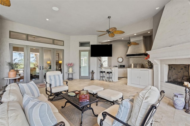 living room featuring ceiling fan, french doors, a high ceiling, and recessed lighting