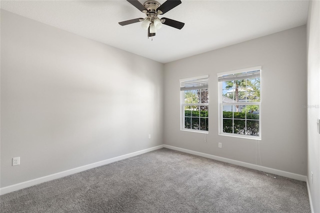 carpeted empty room featuring ceiling fan