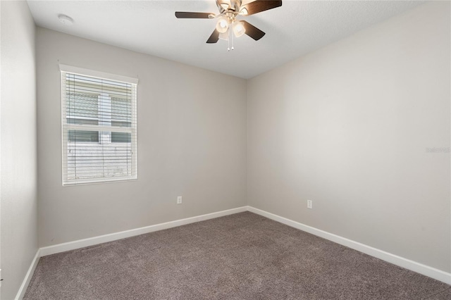 empty room featuring ceiling fan, carpet floors, and baseboards