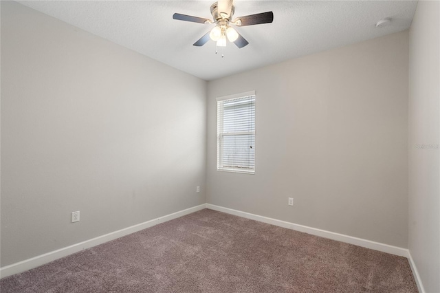 carpeted empty room featuring ceiling fan, a textured ceiling, and baseboards