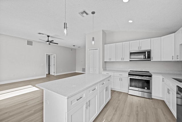 kitchen featuring light hardwood / wood-style flooring, white cabinets, ceiling fan, appliances with stainless steel finishes, and vaulted ceiling