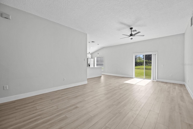 unfurnished living room featuring light hardwood / wood-style floors, a textured ceiling, ceiling fan, and vaulted ceiling