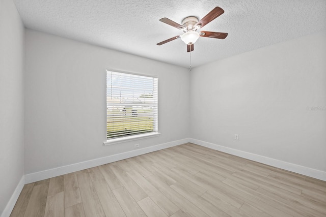 empty room featuring light hardwood / wood-style flooring, a textured ceiling, and ceiling fan