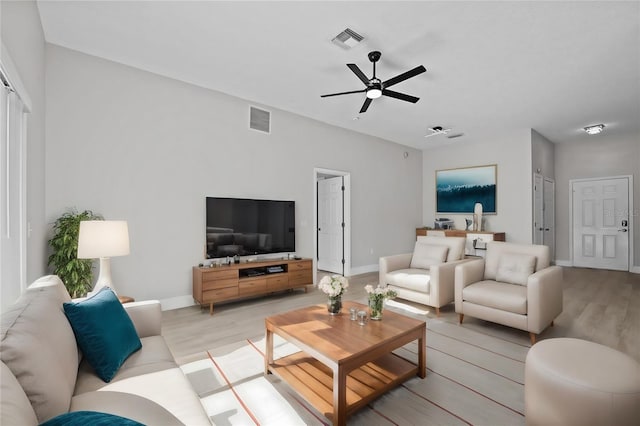 living room featuring light wood-type flooring and ceiling fan