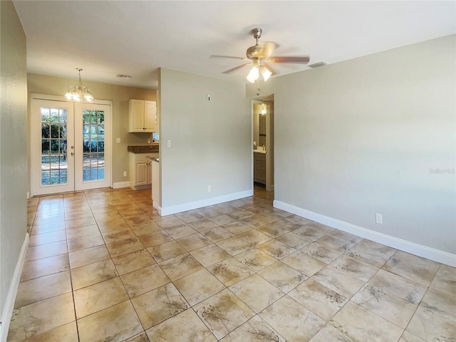 unfurnished room with french doors, light tile patterned floors, and ceiling fan with notable chandelier