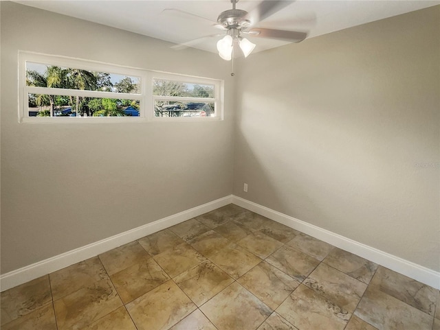 tiled spare room with ceiling fan