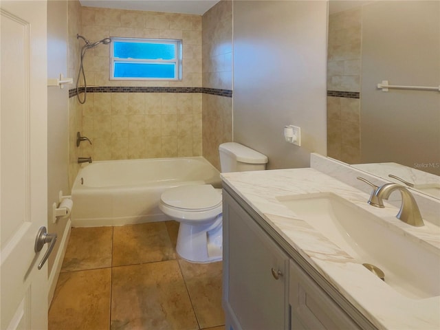 full bathroom with vanity, tile patterned flooring, tiled shower / bath, and toilet