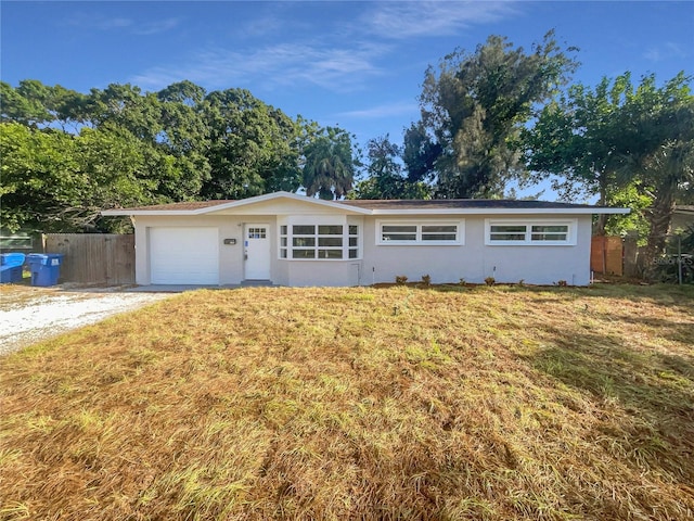 ranch-style house with a garage and a front yard