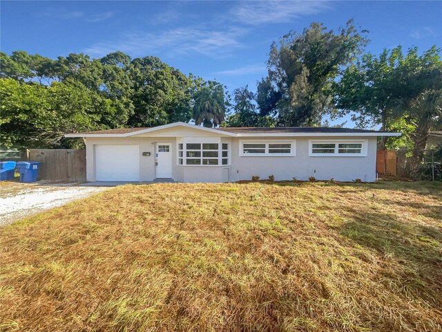 ranch-style home with a front yard and a garage