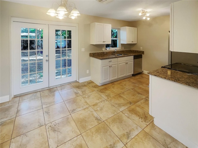 kitchen featuring white cabinets, dishwasher, hanging light fixtures, and light tile patterned floors