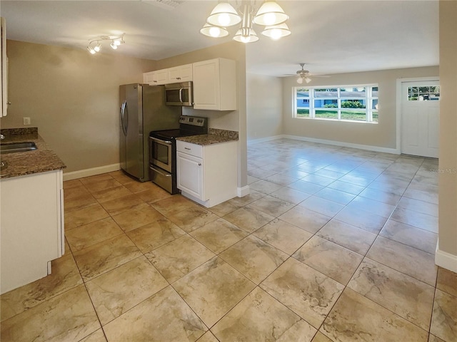 kitchen with hanging light fixtures, white cabinets, light tile patterned floors, and stainless steel appliances