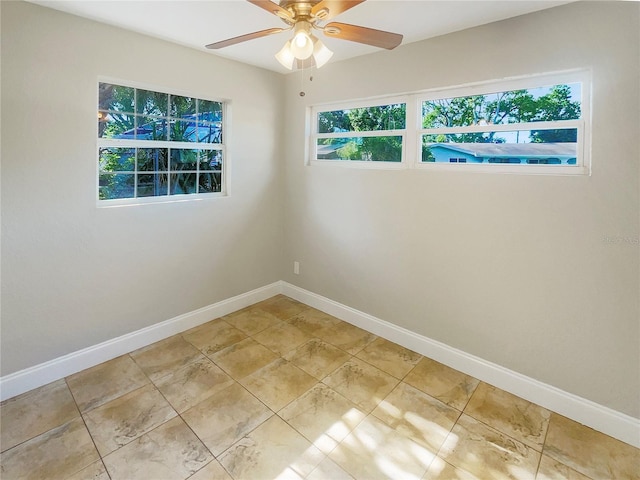 spare room featuring light tile patterned floors and ceiling fan