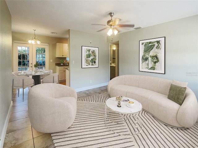 tiled living room with ceiling fan with notable chandelier