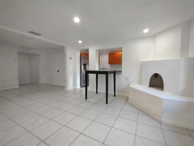 empty room featuring sink and light tile patterned floors