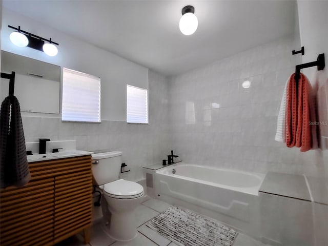 bathroom with tile patterned flooring, a washtub, tile walls, toilet, and vanity