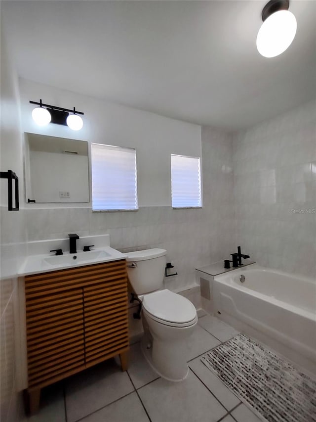 bathroom featuring vanity, tile walls, toilet, and tile patterned floors