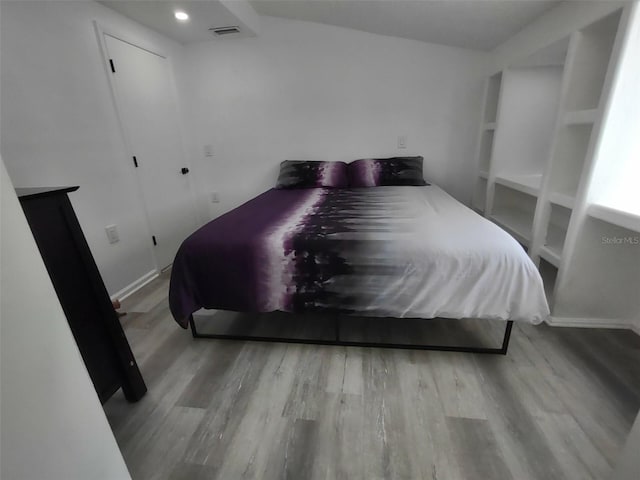 bedroom with hardwood / wood-style floors