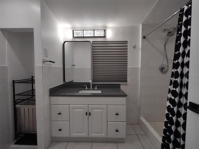 bathroom with tile walls, tile patterned floors, vanity, and a shower with shower curtain