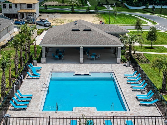 view of pool featuring a yard and a patio