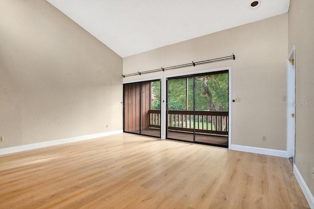 unfurnished room featuring high vaulted ceiling and light hardwood / wood-style floors