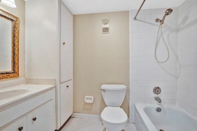 full bathroom featuring toilet, vanity, tiled shower / bath, and tile patterned floors