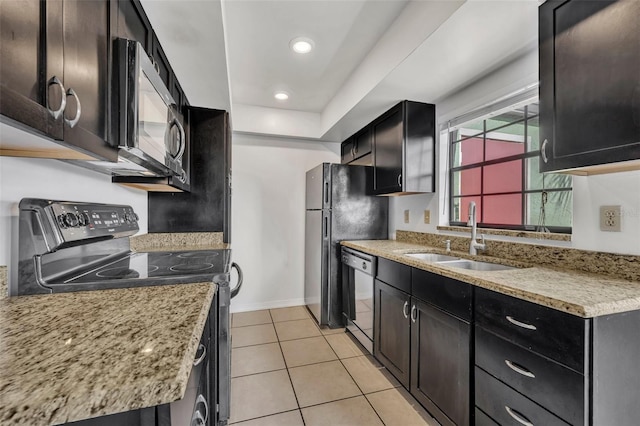 kitchen with light tile patterned flooring, light stone countertops, sink, and black appliances