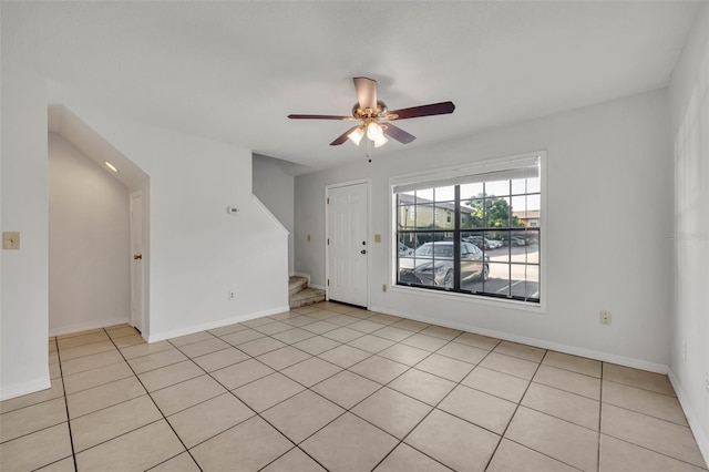 empty room featuring ceiling fan and light tile patterned flooring