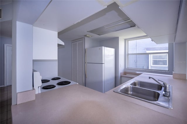 kitchen featuring sink, white appliances, and extractor fan