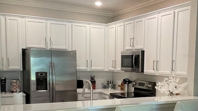 kitchen featuring stainless steel appliances and white cabinets