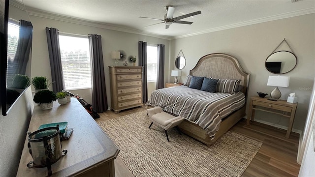 bedroom with ceiling fan, light wood-type flooring, and crown molding