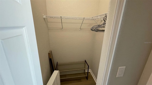 spacious closet featuring hardwood / wood-style floors