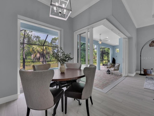 dining room featuring ornamental molding, light hardwood / wood-style flooring, and an inviting chandelier