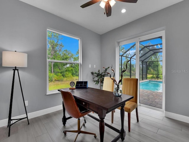 office with ceiling fan and light hardwood / wood-style flooring