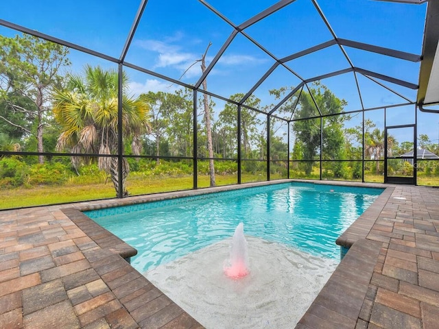 view of pool with a patio and a lanai