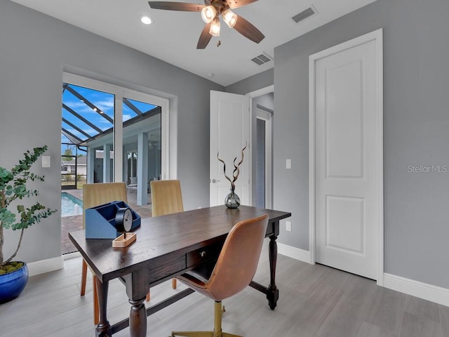 office space with light hardwood / wood-style flooring and ceiling fan