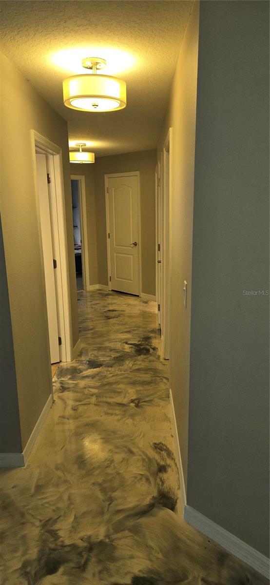 hallway with a textured ceiling