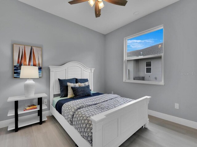 bedroom with light hardwood / wood-style flooring and ceiling fan