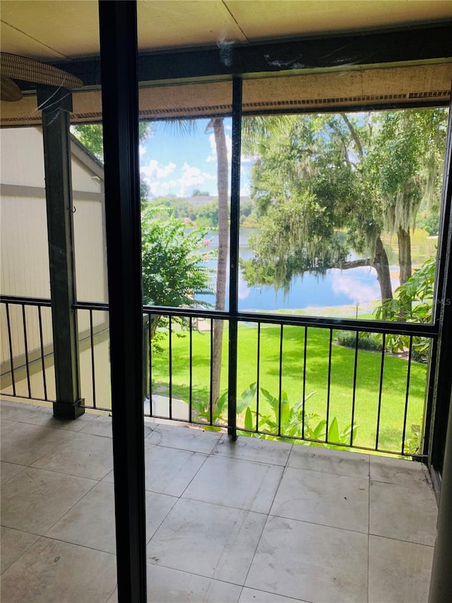 unfurnished sunroom featuring a healthy amount of sunlight and a water view