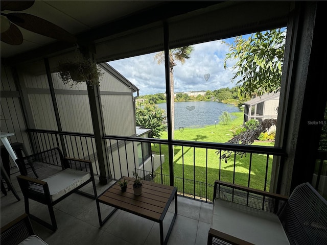 sunroom / solarium featuring a water view