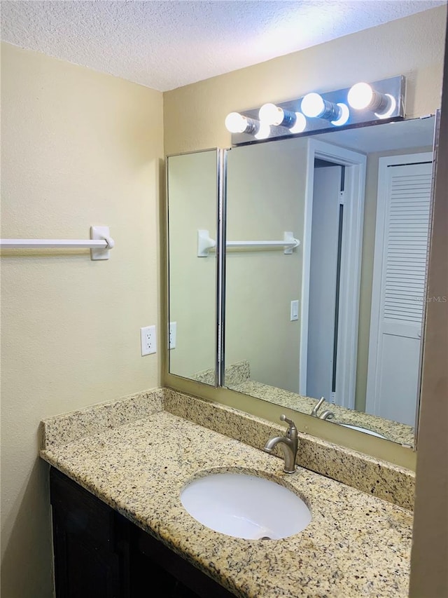 bathroom with vanity and a textured ceiling