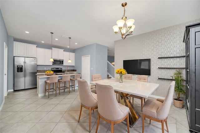 dining space with stairs, light tile patterned flooring, a chandelier, and wallpapered walls