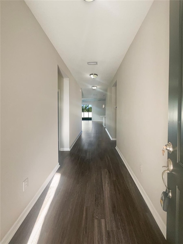 hallway with dark hardwood / wood-style floors