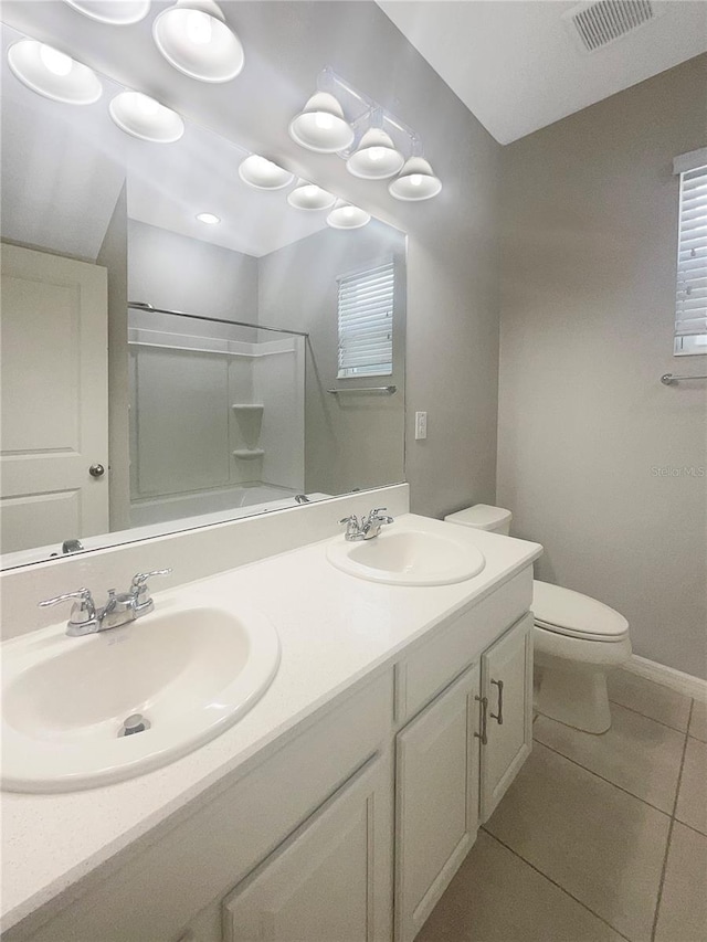 bathroom featuring dual vanity, tile patterned floors, and toilet