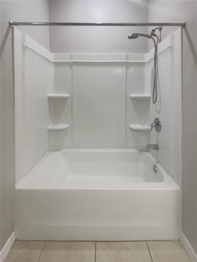 bathroom featuring shower / washtub combination and tile patterned flooring