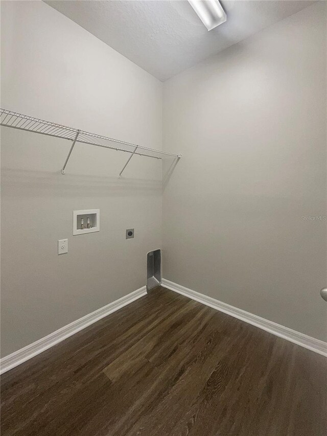 clothes washing area featuring hardwood / wood-style flooring, hookup for an electric dryer, and washer hookup